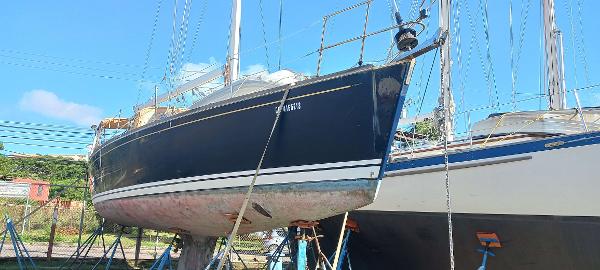Tartan 3700 Tartan 3700 sailboat from 2003 on stands, blue hull, clear sky background.