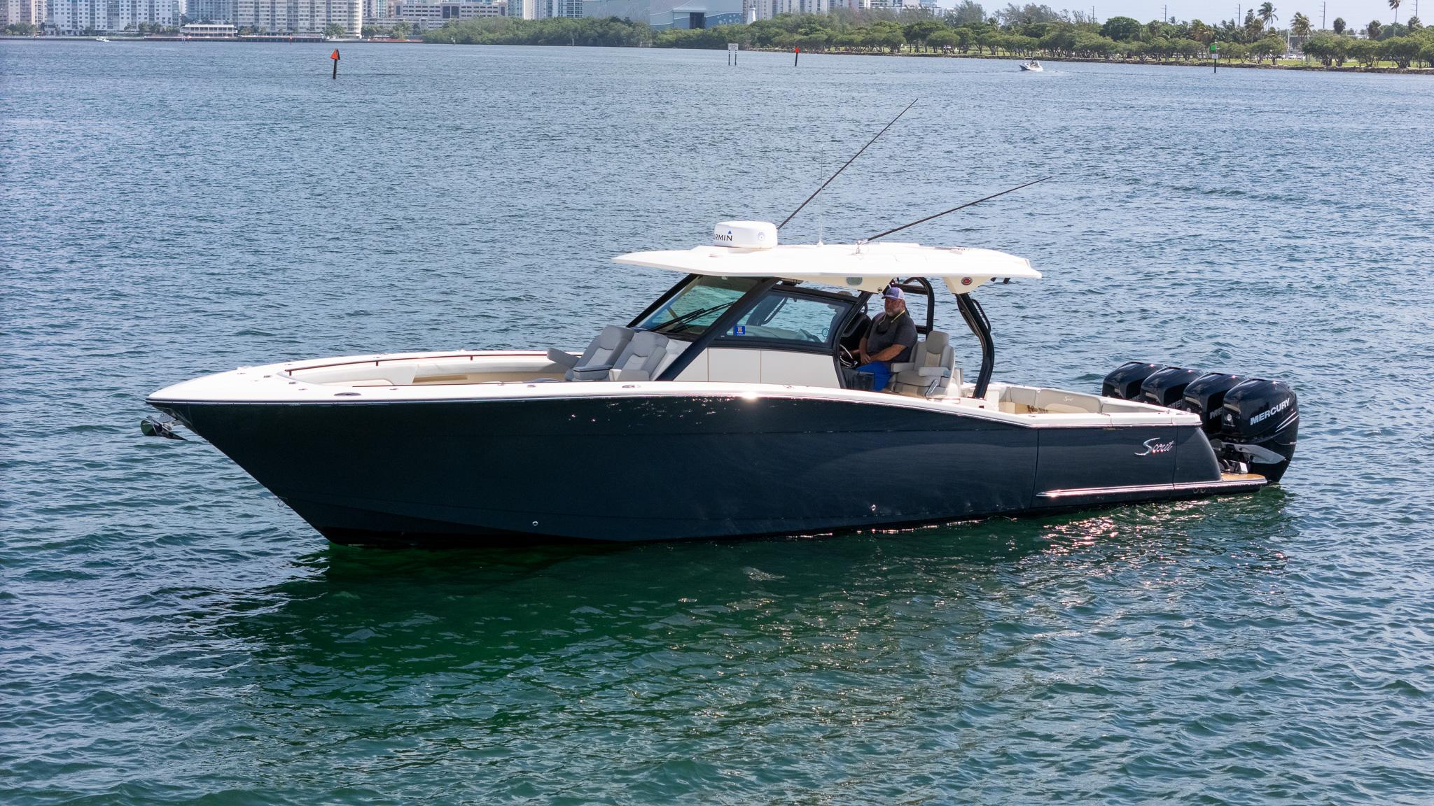 Scout 380 LXF 2020 Scout 380 LXF boat on water with city skyline in background.