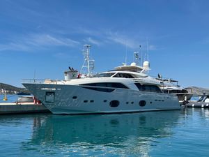 Custom Line 100 Luxurious 2011 Custom Line 100 yacht docked in a serene marina under clear blue skies.