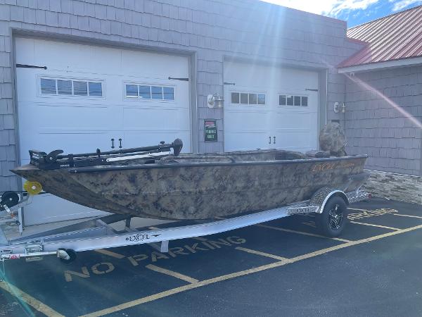 Excel 1751 River Warrior 2025 Excel 1751 River Warrior boat on trailer, parked outside garage.