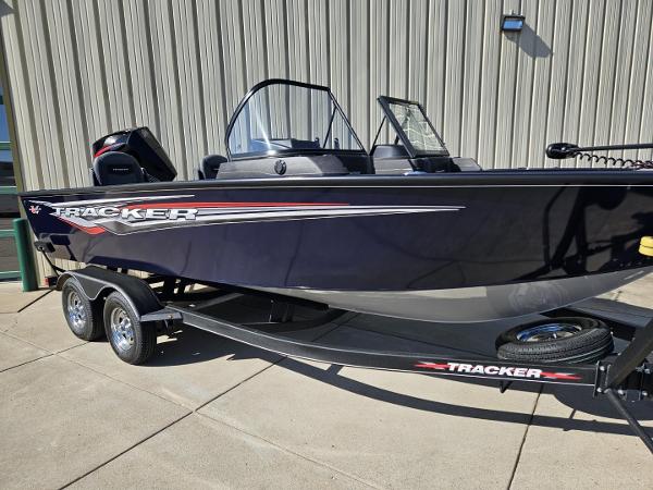 Tracker Targa V-19 WT 2023 Tracker Targa V-19 WT boat on trailer, parked outside.