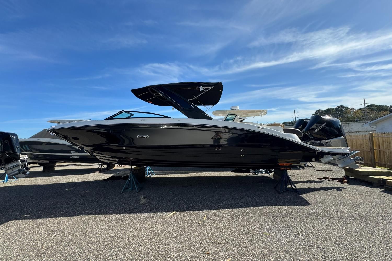 Sea Ray SDX 290 Outboard 2026 Sea Ray SDX 290 Outboard boat on display under clear blue sky.