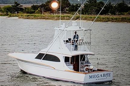 Custom Carolina Scarborough Custom Carolina Scarborough 1984 yacht "Megabite" on water, featuring a sleek design and fishing equipment.