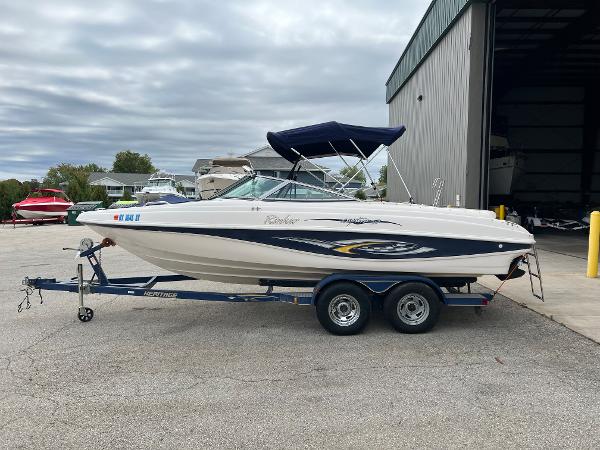 Rinker 212 Captiva Bowrider 2002 Rinker 212 Captiva Bowrider on trailer, parked outside a storage facility.