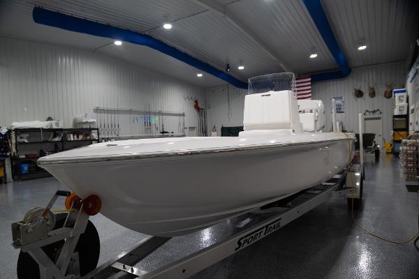 Contender 23 Bay 2024 Contender 23 Bay boat on trailer in indoor showroom.