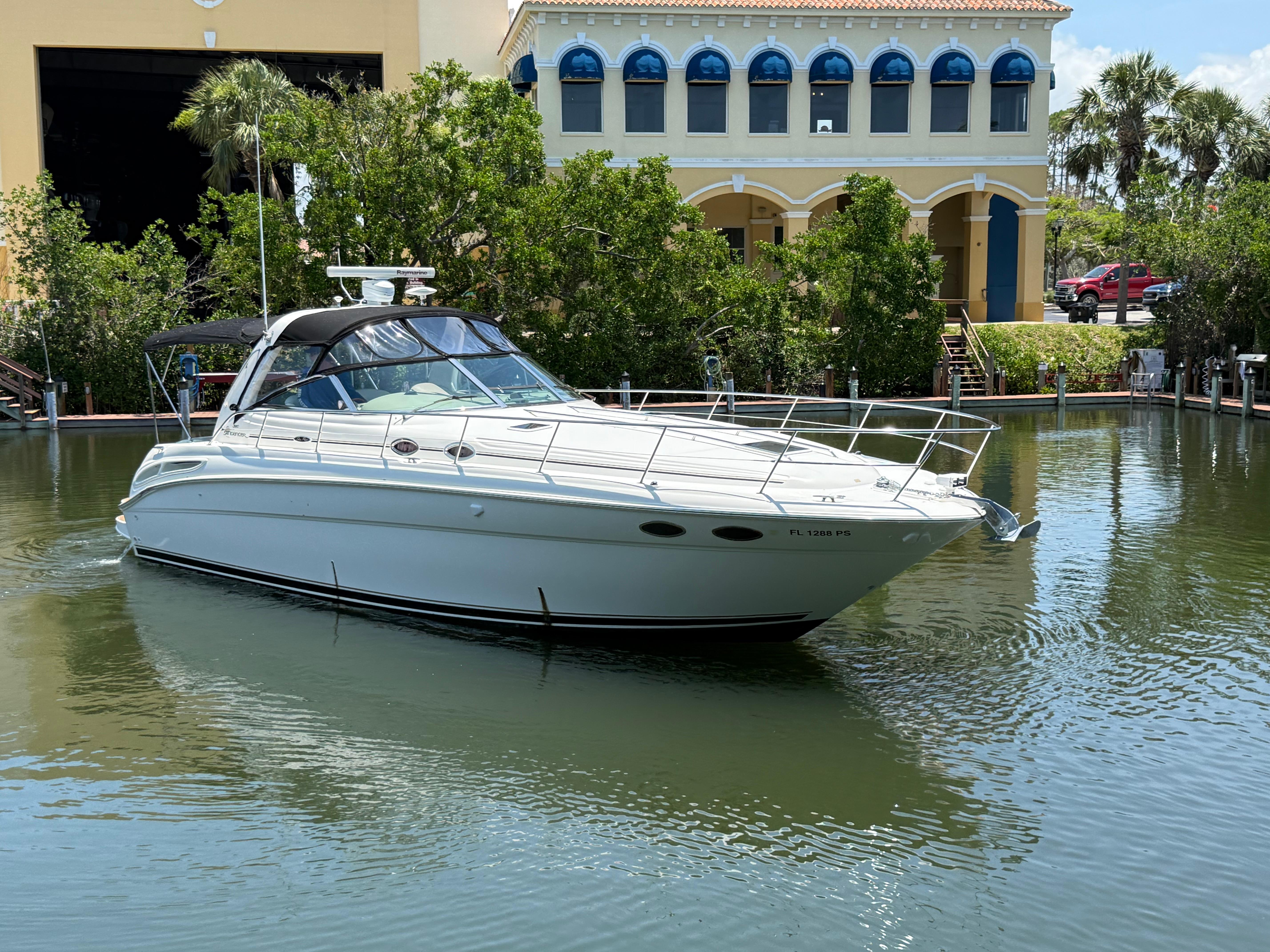 Sea Ray 380 Sundancer 2003 Sea Ray 380 Sundancer yacht docked in a serene marina setting.