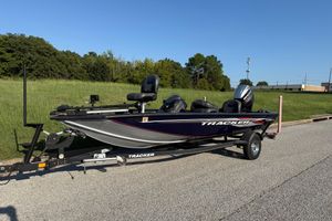 Tracker Pro Team 175 TF 2019 Tracker Pro Team 175 TF boat on trailer, parked on roadside.