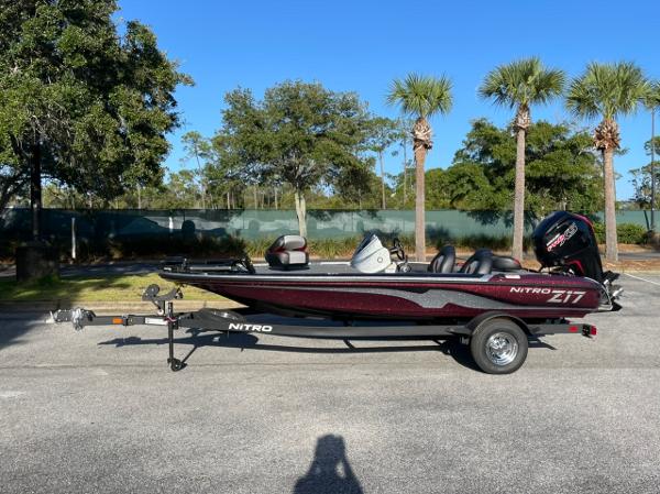 Nitro Z17 2025 Nitro Z17 boat on trailer, parked outdoors with trees in background.
