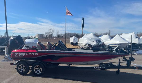 Nitro Z19 Pro 2025 Nitro Z19 Pro boat in red and black, parked outdoors under a clear sky.