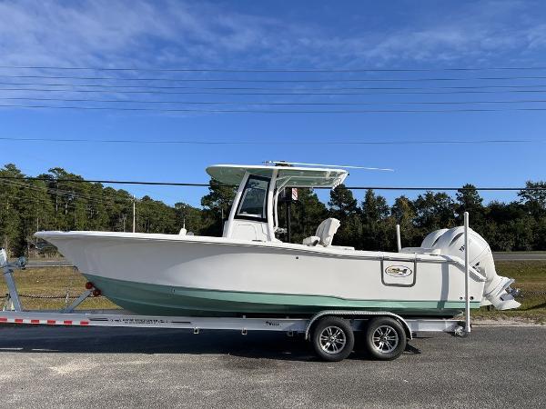 Sea Hunt Ultra 265 SE 2025 Sea Hunt Ultra 265SE boat on trailer, side view, clear sky background.