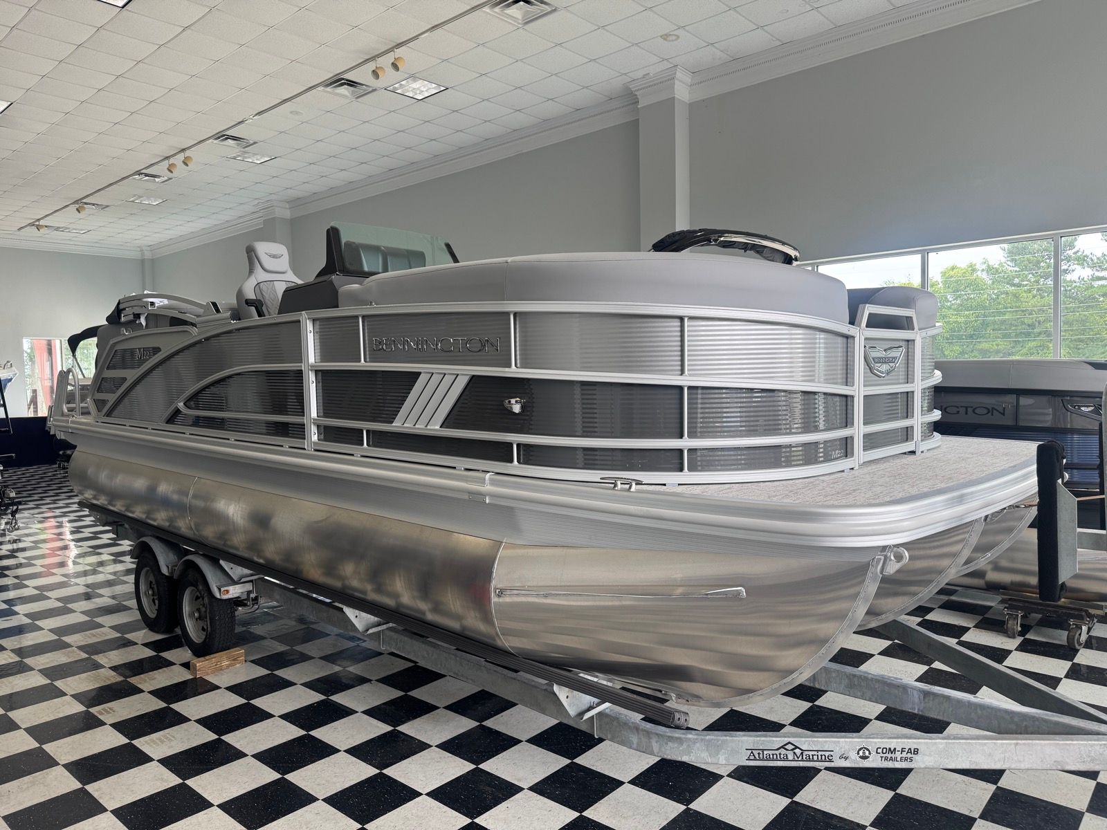 Bennington 22MFB 2026 Bennington 22MFB pontoon boat displayed indoors on a trailer.
