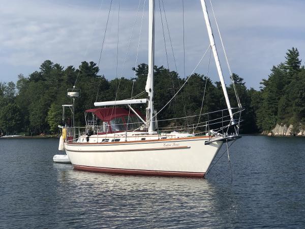 Gulfstar 44 Center Cockpit 1980 Gulfstar 44 Center Cockpit sailboat anchored on a calm lake with forested shoreline.