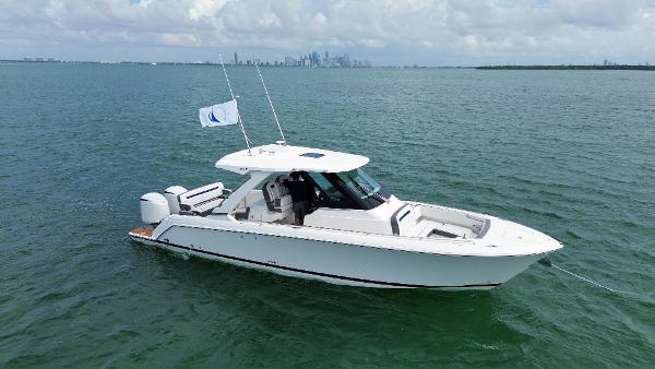 Tiara Sport 34 LS 2021 Tiara Sport 34 LS boat cruising on open water with city skyline in background.