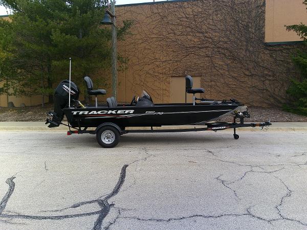 Tracker Pro 170 2025 Tracker Pro 170 boat on trailer, parked outdoors.