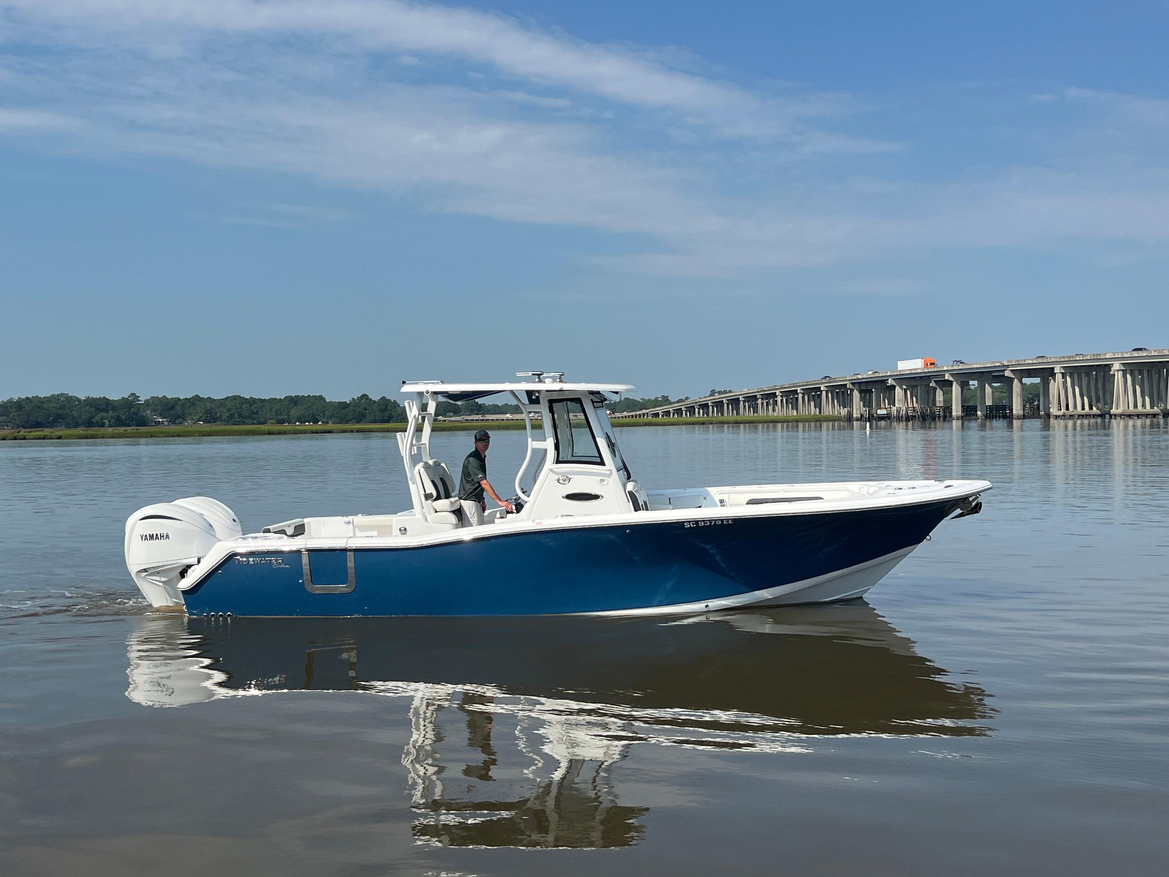Tidewater 292 CC Adventure 2024 Tidewater 292 CC Adventure boat cruising on calm waters near a bridge.