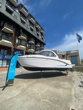 Beneteau Antares 7 OB V2 2023 Beneteau ANTARES 7 OB V2 boat displayed outdoors near a building.