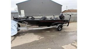 Xpress H18 2025 Xpress H18 boat on trailer, black exterior, parked outdoors.
