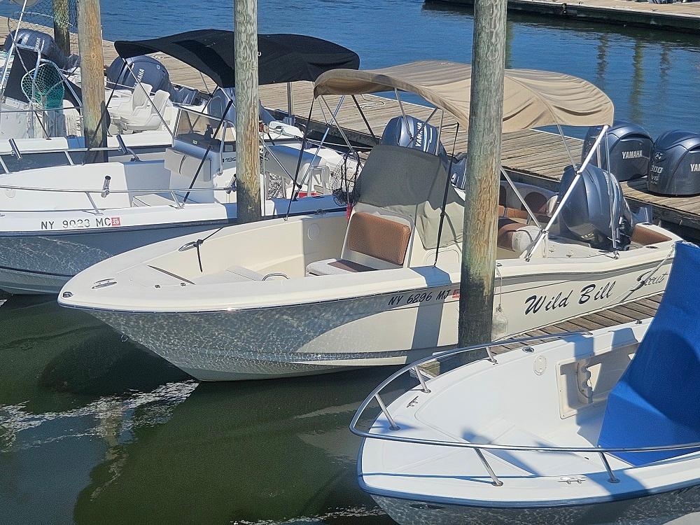 Scout 195 Sportfish 2013 Scout 195 Sportfish boat docked at marina with Yamaha engines.