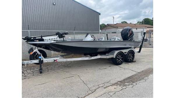 Xpress X19 Pro 2024 Xpress X19 Pro boat on trailer, parked outdoors near a building.