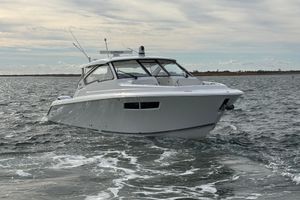 Pursuit DC 365 Dual Console 2022 Pursuit DC 365 Dual Console boat cruising on open water.