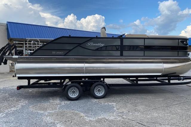 Bentley Pontoons Legacy 223 Swingback 2025 Bentley Pontoons Legacy 223 Swingback on trailer, sleek design, blue sky background.