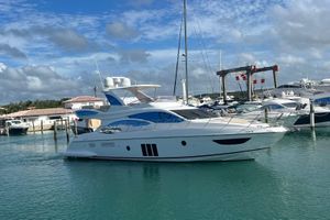 Azimut Azimut Fly 2017 Azimut Fly yacht docked in a marina under a partly cloudy sky.