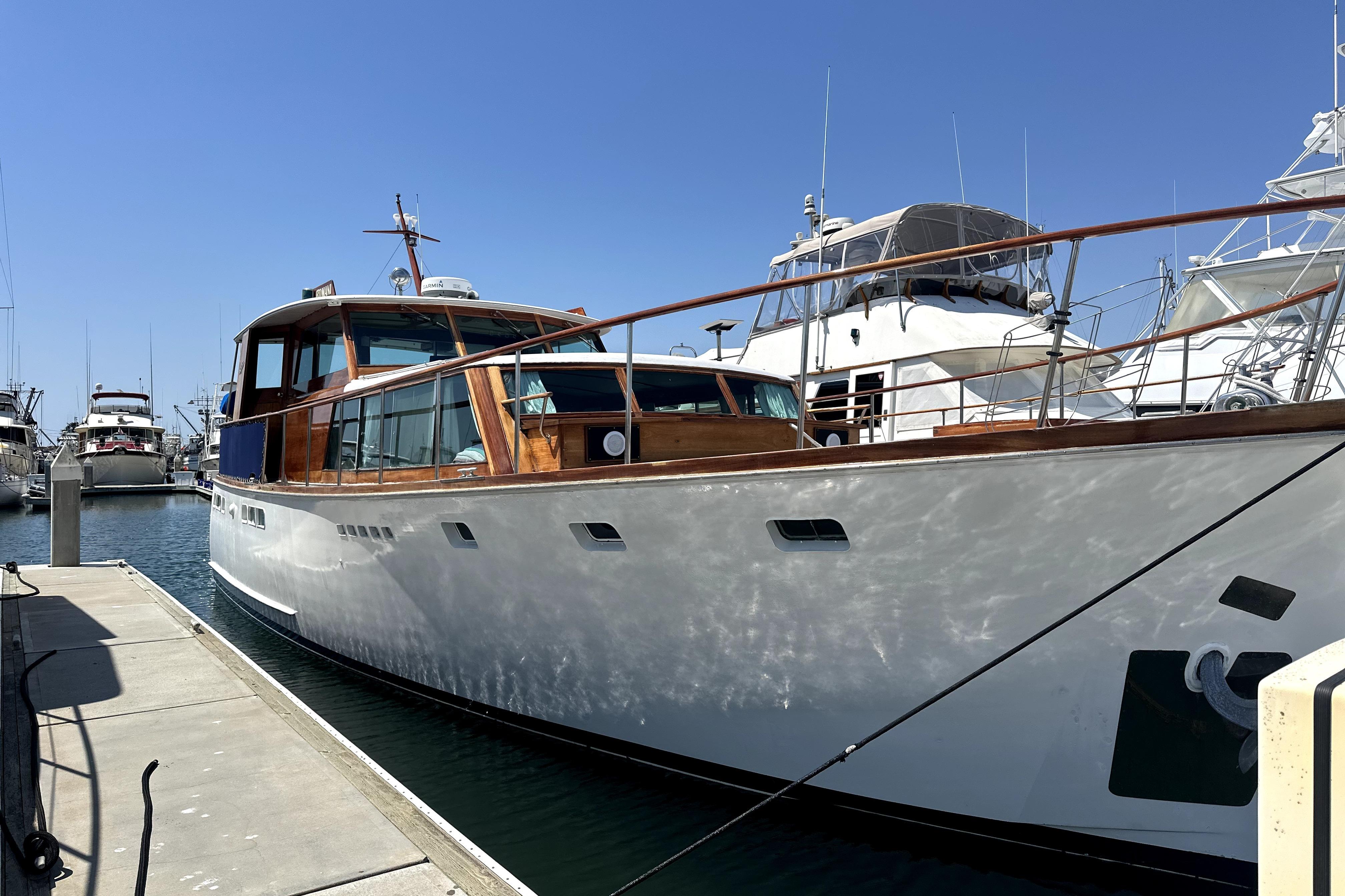 Stephens Brothers flush deck motor yacht 1969 Stephens Brothers flush deck motor yacht docked at marina under clear blue sky.