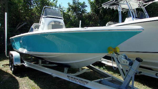 Key West 210 Bay Reef 2025 Key West 210 Bay Reef boat on trailer, turquoise hull, parked outdoors.