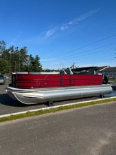 Trifecta 24ECS275 2025 Trifecta 24ECS275 pontoon boat with red exterior, parked outdoors.