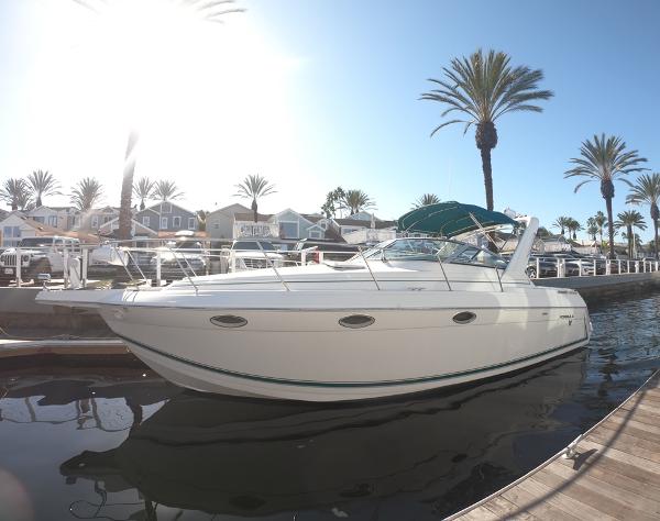 Formula 31 PC 1998 Formula 31 PC yacht docked in sunny marina with palm trees.