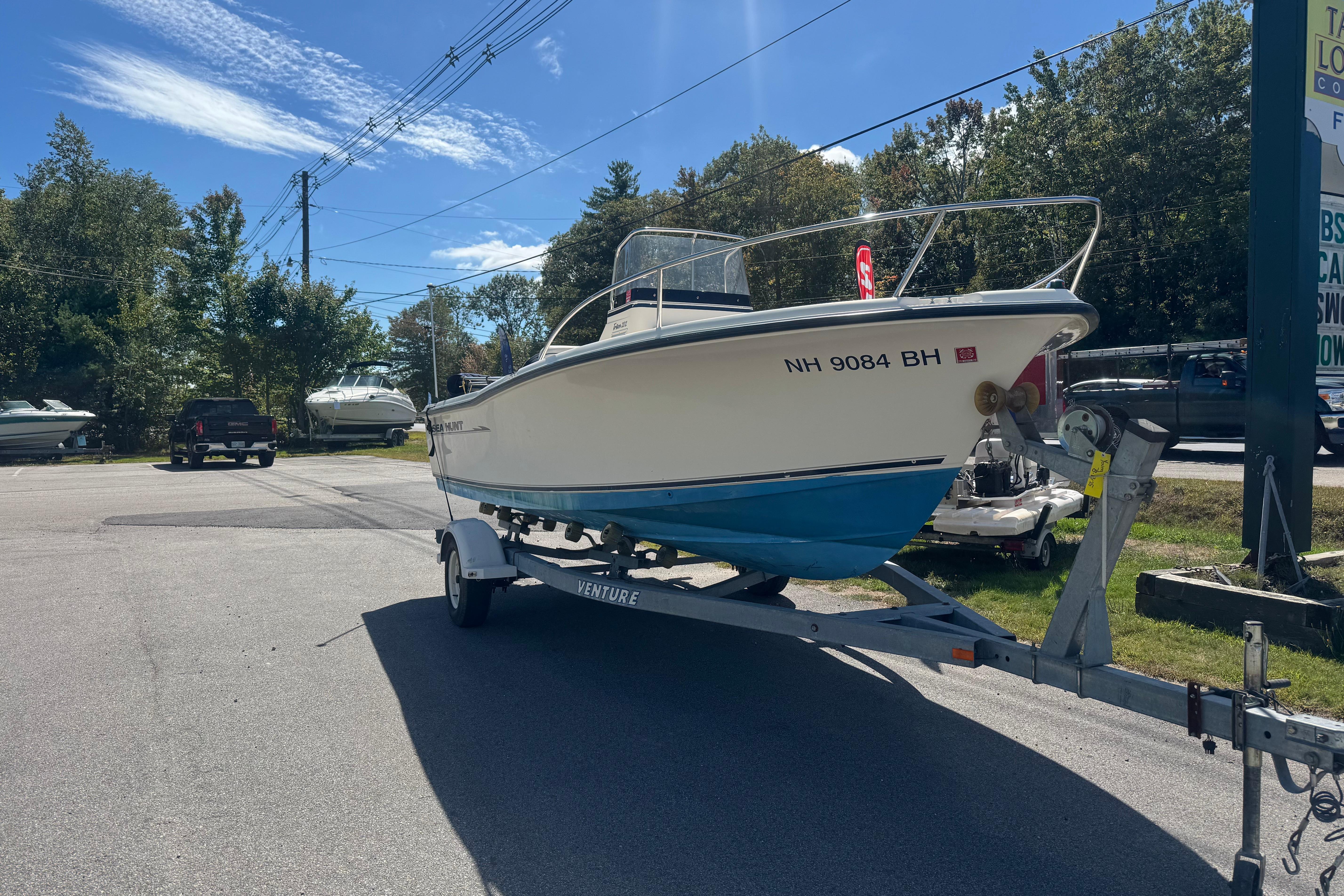 Sea Hunt Triton 202 2002 Seahunt Triton 202 boat on trailer in sunny outdoor setting.