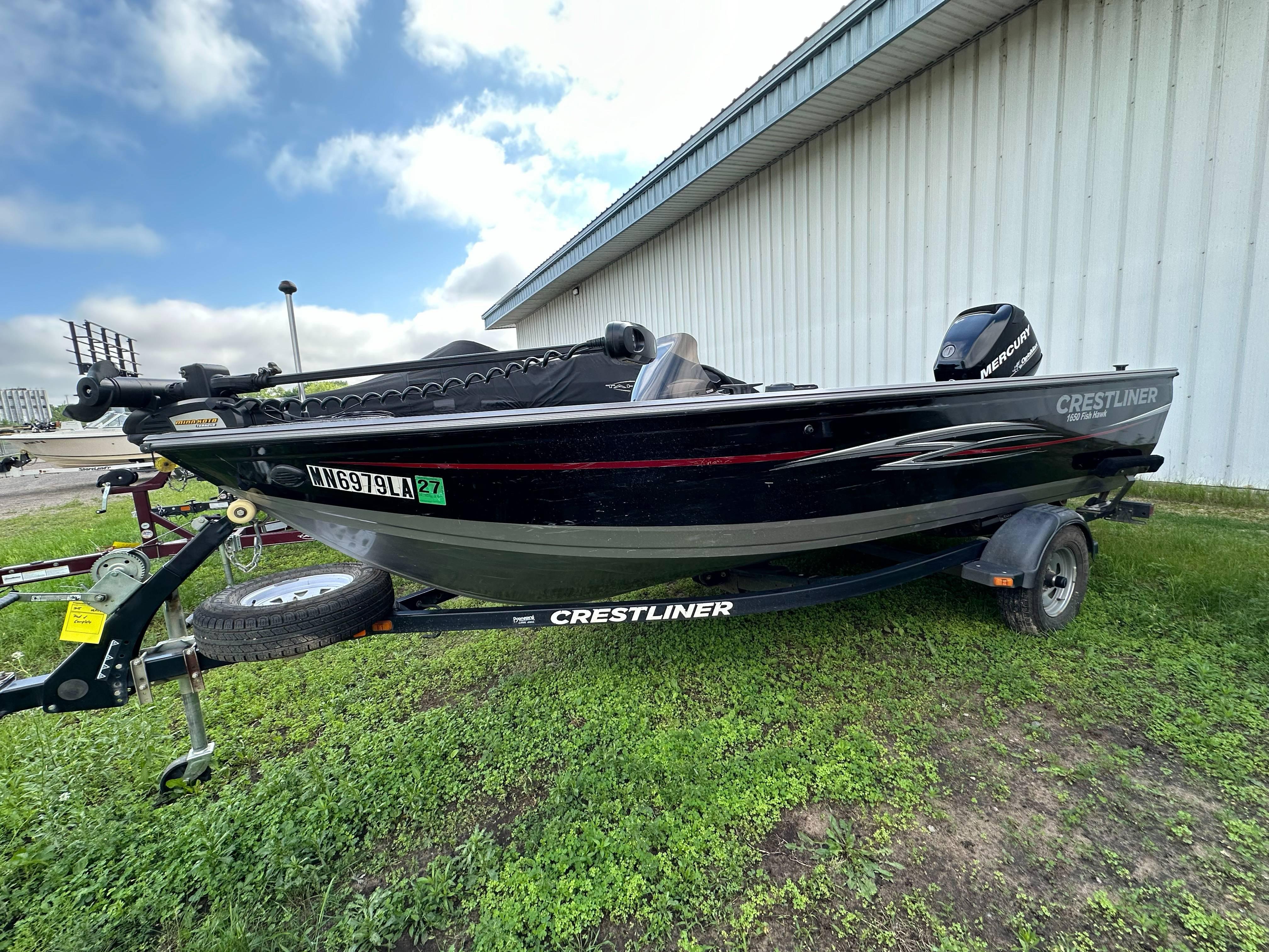 Crestliner Fish Hawk 1650 SC 2013 Crestliner Fish Hawk 1650 SC boat on trailer, parked on grass.