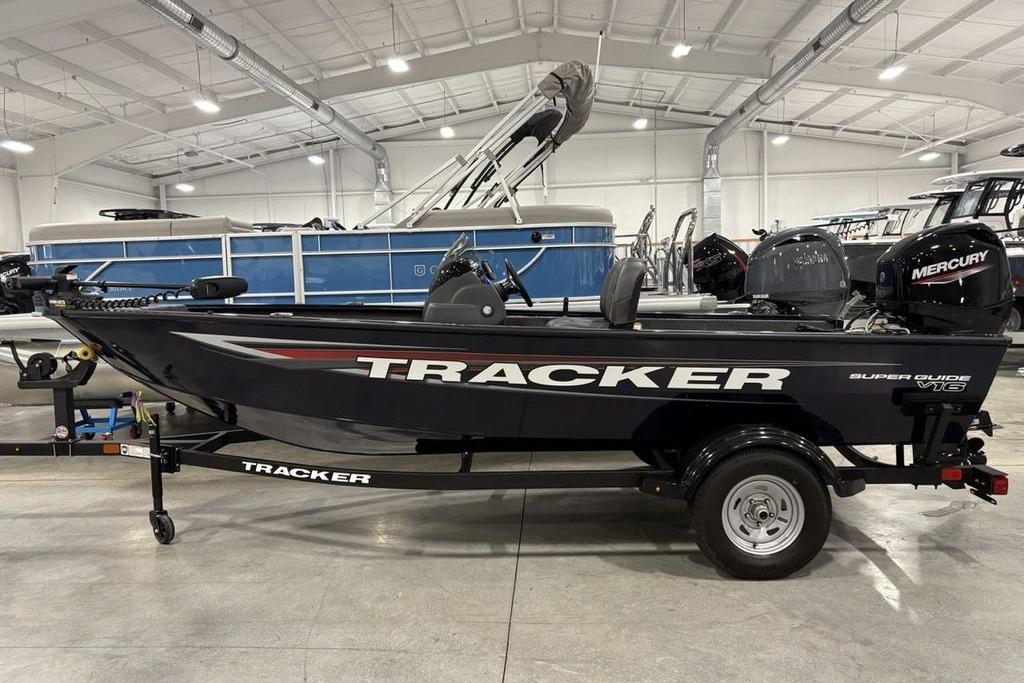 Tracker Super Guide V-16 SC 2026 Tracker Super Guide™ V-16 SC boat in showroom, side view with Mercury engine.