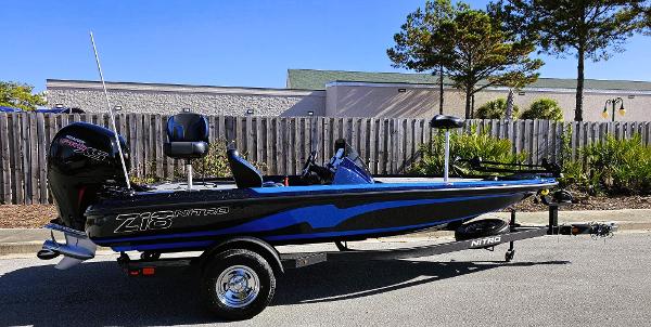 Nitro Z18 2025 Nitro Z18 boat on trailer, parked outdoors, side view.
