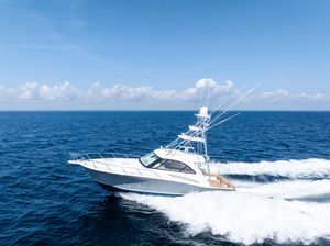 Hatteras Express Sportfish 2016 Hatteras Express Sportfish cruising on open ocean under clear blue sky.