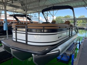 Harris Solstice 250 2026 Harris Solstice 250 pontoon boat docked under a covered marina.