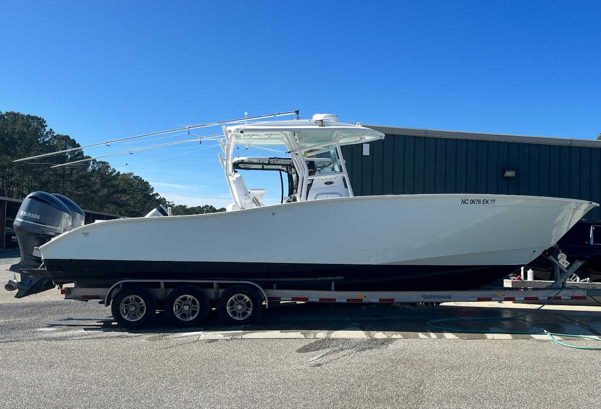 Cape Horn 31 2019 Cape Horn 31 boat on trailer, parked outdoors under clear blue sky.