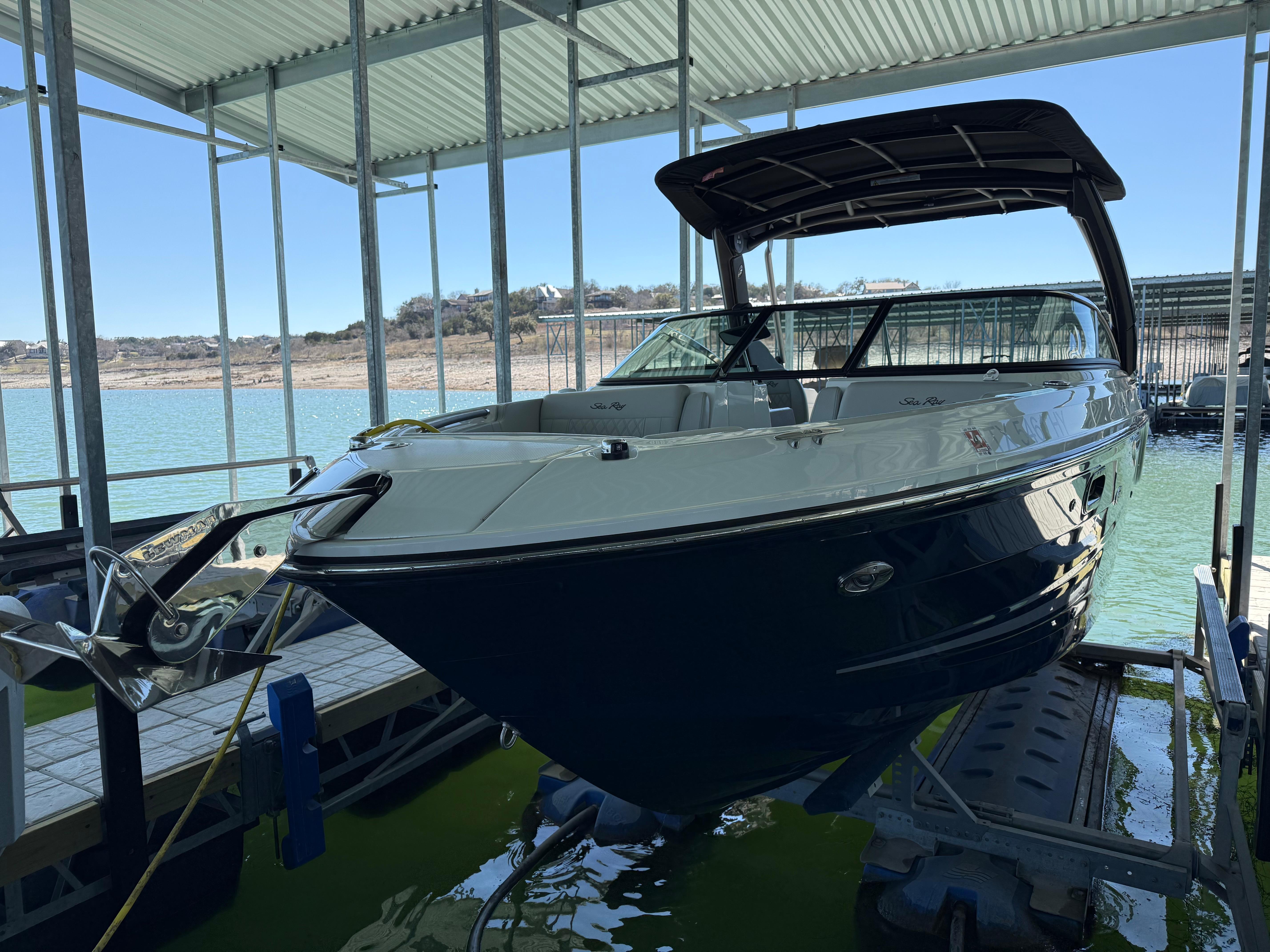 Sea Ray SLX 250 2021 Sea Ray SLX 250 boat docked in a covered marina.