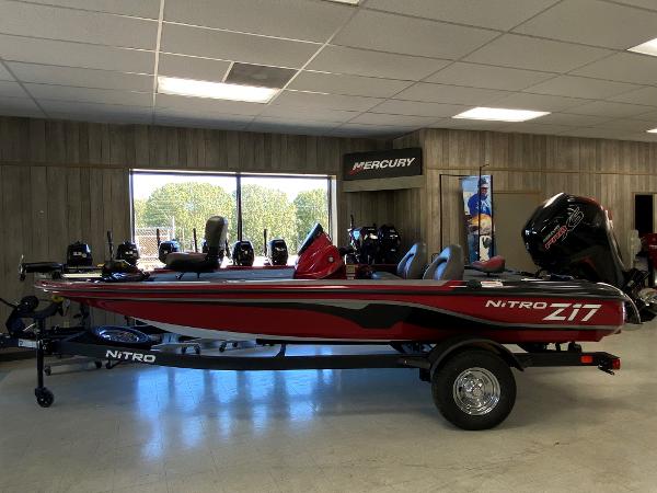 Nitro Z17 2025 Nitro Z17 boat in showroom, red and black design, on trailer.