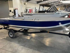 Crestliner 1672 Outreach 2024 Crestliner 1672 Outreach boat on trailer in showroom setting.