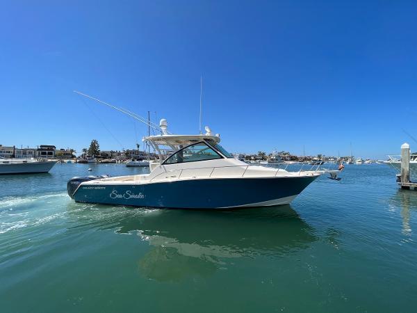 Grady-White Express 370 2019 Grady-White Express 370 boat cruising in a sunny marina.
