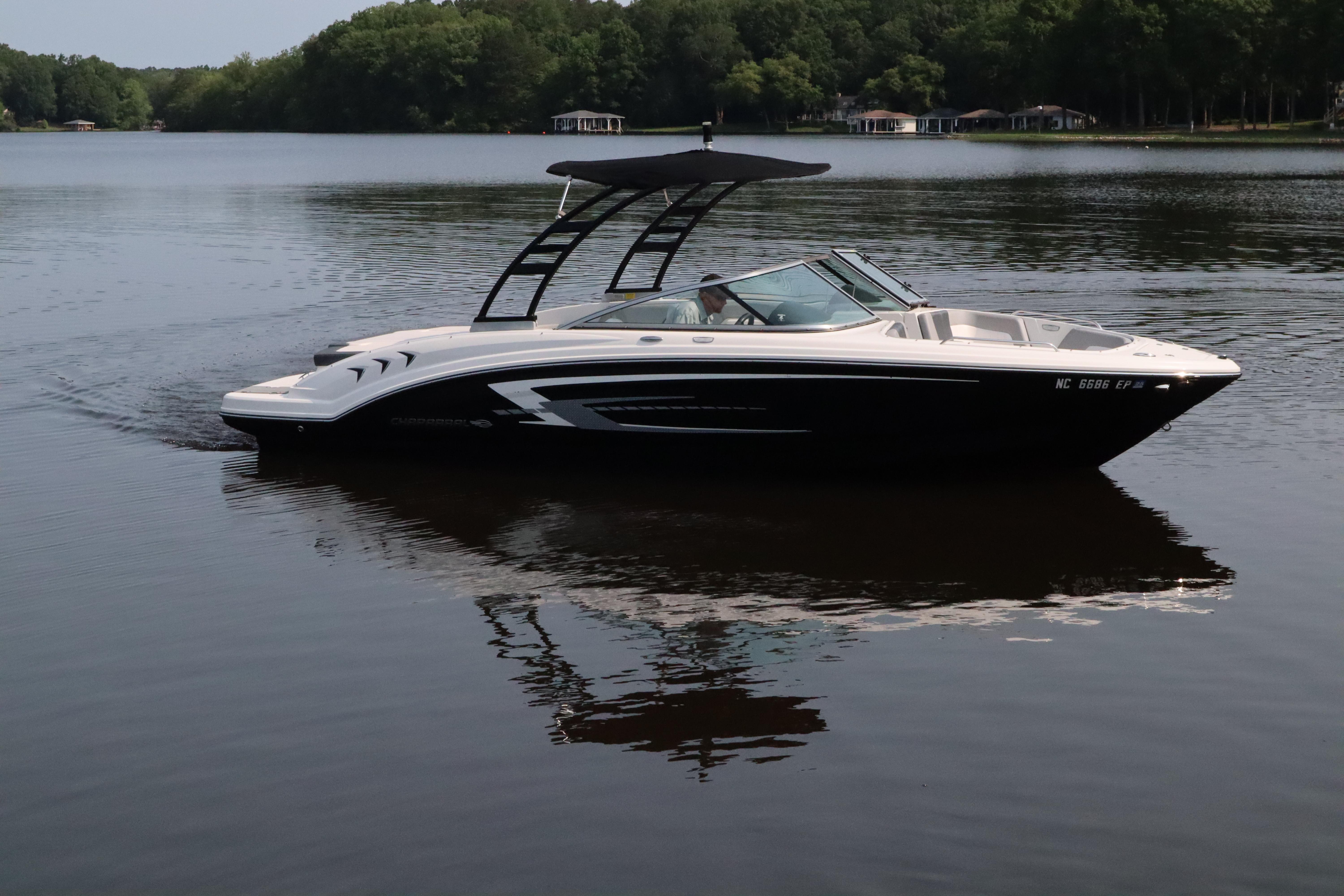 Chaparral 23 SSi 2020 Chaparral 23 SSi boat cruising on a calm lake with forested shoreline.