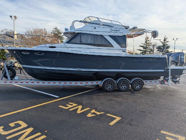 Cutwater C-32 CB 2022 Cutwater C-32 CB boat on trailer in parking lot.
