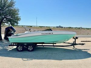 Tahoe T21 2025 Tahoe T21 boat on trailer, parked outdoors under clear sky.