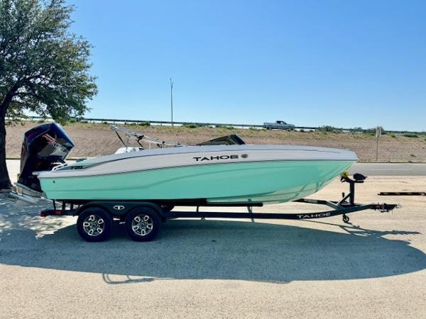 Tahoe T21 2025 Tahoe T21 boat on trailer, parked outdoors under clear sky.