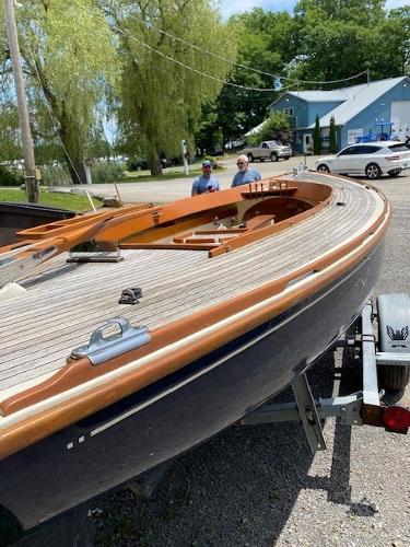 Tofinou 7m 2001 Tofinou 7m sailboat on trailer, wooden deck, outdoor setting.