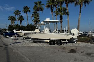 Tidewater 2300 Carolina Bay 2024 Tidewater 2300 Carolina Bay boat on trailer, parked near palm trees and marina.