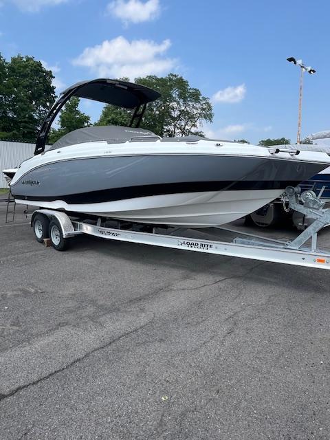 NauticStar 243 DC 2025 NauticStar 243 DC boat on trailer, parked outdoors under a clear sky.