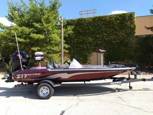 Nitro Z17 2025 Nitro Z17 boat on trailer, parked outdoors, side view.