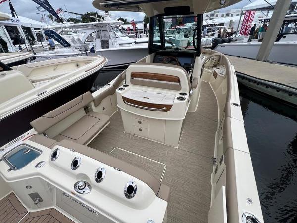 Chris-Craft Catalina 28 2024 Chris-Craft Catalina 28 boat interior at a marina, showcasing seating and storage.